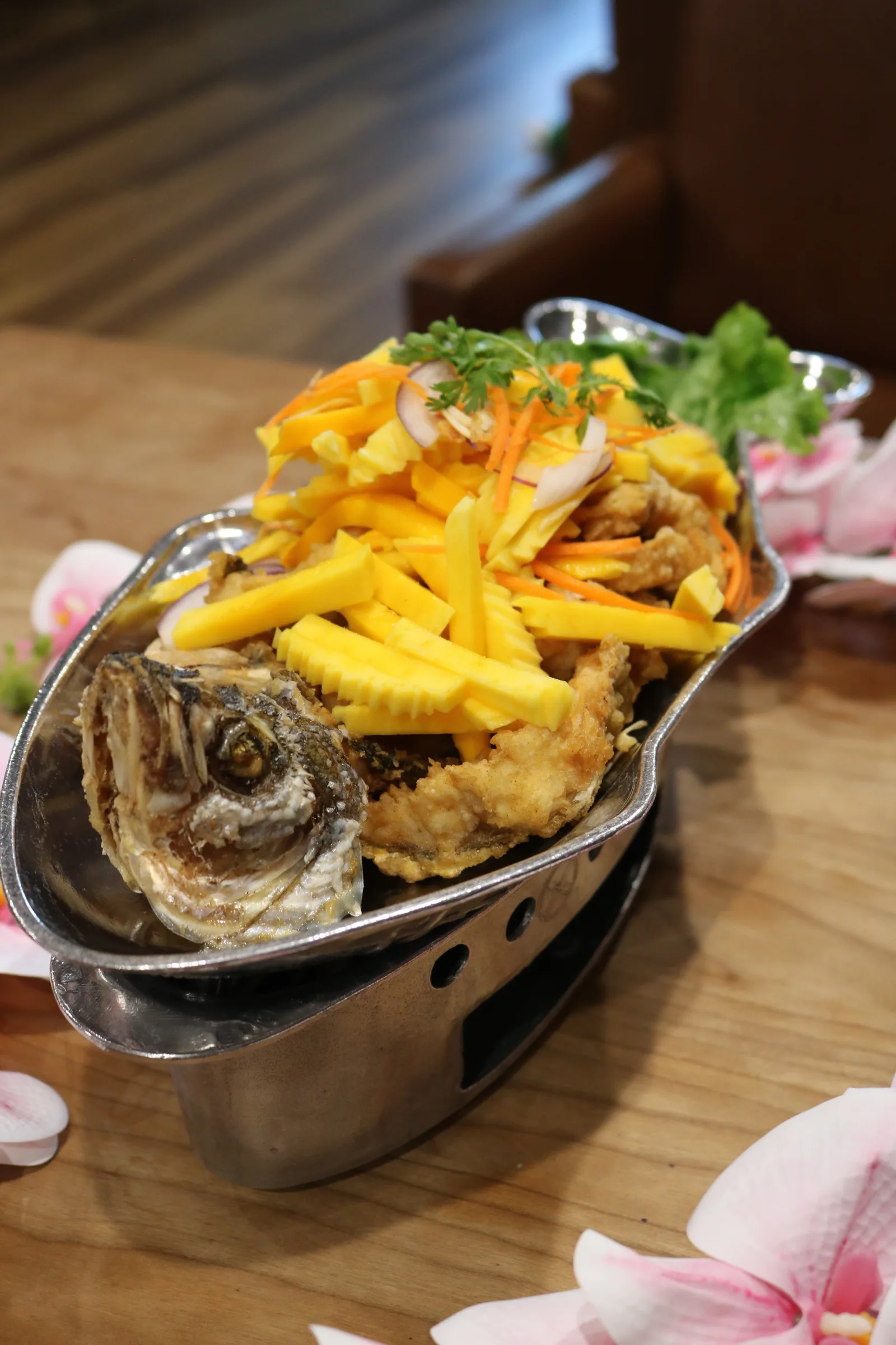 Fried fish topped with fresh mango salad